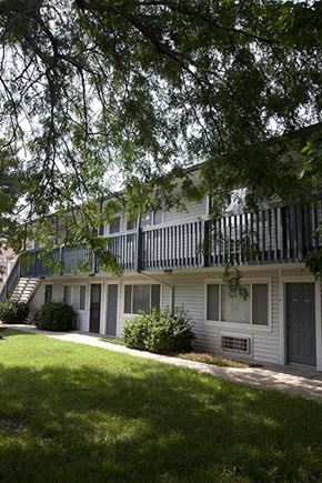 Wichita apartment for rent - a white house with a balcony and a yard