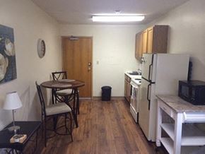 Wichita apartment for rent - a small kitchen with a table and a refrigerator