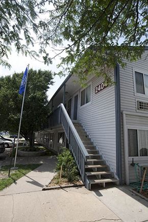 Wichita apartment for rent - a white house with stairs and a blue flag