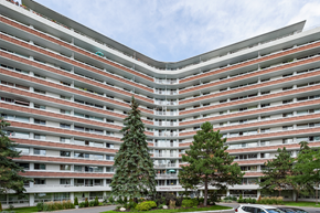 Ottawa apartment for rent - an exterior view of a large building with trees in front of it