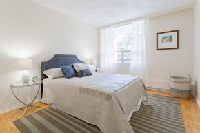 Ottawa apartment for rent - a bedroom with a bed and a window