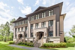 Ottawa townhouse for rent - the exterior of a large brick house with stairs and grass