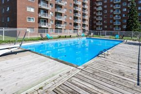 Gatineau apartment for rent - a swimming pool in front of an apartment building