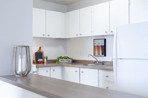Gatineau apartment for rent - a kitchen with white cabinets and a white refrigerator