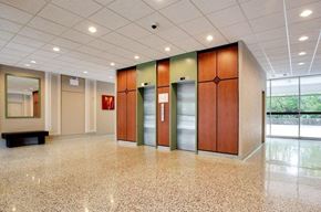 Ottawa apartment for rent - a large lobby with three elevators in a building