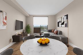 Ottawa apartment for rent - A modern dining room with a round marble table and grey chairs.