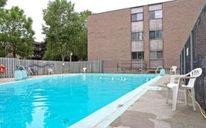 Kingston apartment for rent - a swimming pool in front of a building