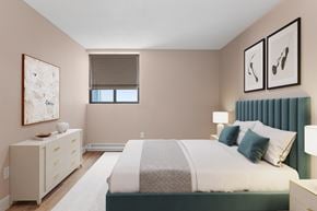 Ottawa apartment for rent - A bedroom with a large bed and a dresser with a painting on top.