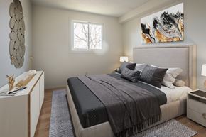 Kingston apartment for rent - A bedroom with a large bed and a painting on the wall.