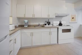 Ottawa apartment for rent - A white kitchen with a sink, stove, and oven.