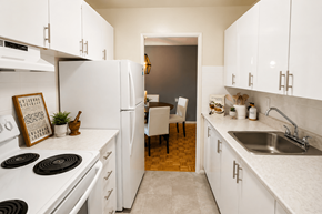 Ottawa apartment for rent - A kitchen with white appliances and cabinets.