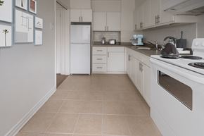 Ottawa apartment for rent - A kitchen with white appliances and cabinets.