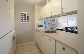 Ottawa apartment for rent - A kitchen with a Prada sign on the wall.