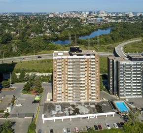 Ottawa apartment for rent - A large building with a pool in front of it.