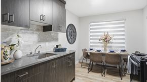 Edmonton apartment for rent - A modern kitchen with a dining table set for two.