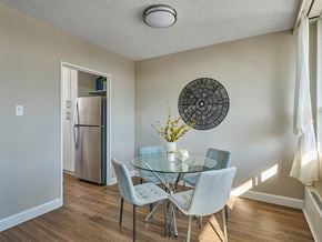 Ottawa apartment for rent - A dining room with a glass table and chairs.