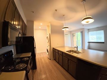 Indianapolis apartment for rent - A modern kitchen with dark wood cabinets and stainless steel appliances.