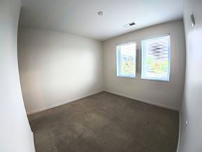 Indianapolis apartment for rent - A room with two windows and a carpeted floor.