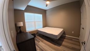 Indianapolis apartment for rent - A bedroom with a bed, dresser, and window.