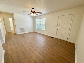 Anderson apartment for rent - A room with a ceiling fan and wooden flooring.
