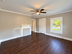 Anderson house for rent - A room with a fireplace and a ceiling fan.