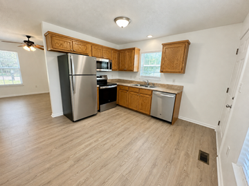 Anderson apartment for rent - A kitchen with wooden cabinets and a stainless steel refrigerator.