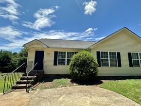 Anderson apartment for rent - A house with a blue sky and clouds in the background.