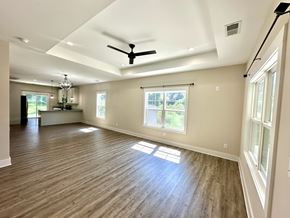 Greenville house for rent - A room with a ceiling fan and wooden flooring.