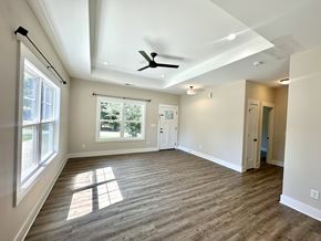 Greenville house for rent - A room with a ceiling fan and a window letting in sunlight.