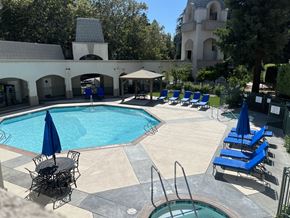Walnut Creek apartment for rent - a swimming pool with blue lounge chairs and umbrellas