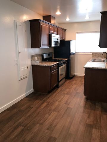 Los Angeles apartment for rent - a kitchen with wooden floors and a stove and a refrigerator