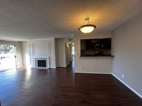 Santa Ana apartment for rent - A living room with a fireplace and a television.