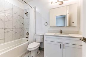 Philadelphia apartment for rent - A white bathroom with a marble tile shower.