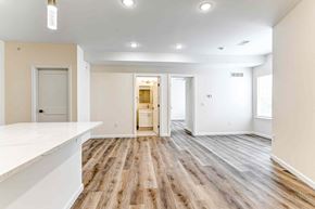 Philadelphia apartment for rent - A spacious room with wooden flooring and white walls.