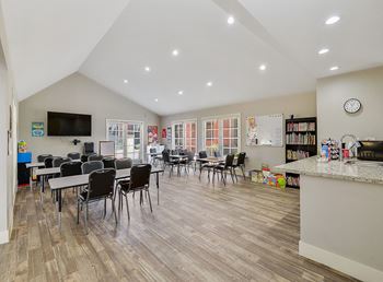 Upscale interiors with hardwood floors, granite countertops, and custom cabinetry