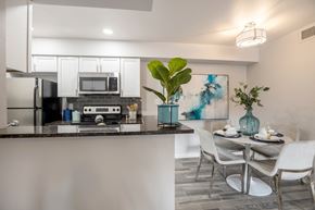 Tempe apartment for rent - Newly renovated large dining area and kitchen with white cabinets, stainless steel appliances, and breakfast bar