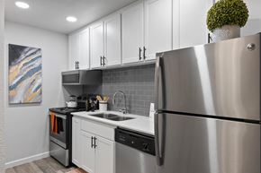 Mesa apartment for rent - a kitchen with white cabinets and stainless steel appliances