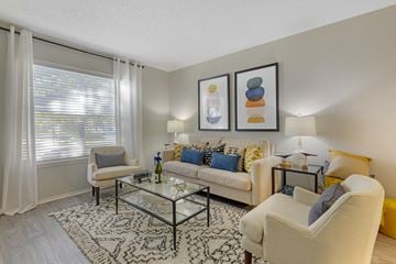 Hurst apartment for rent - a living room with couches and chairs and a glass table