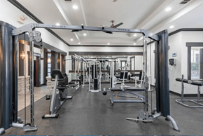 Dallas apartment for rent - A gym with a variety of equipment including a treadmill, a stationary bike, and a rowing machine.
