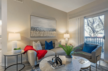 Dallas apartment for rent - A living room with a grey couch, a coffee table, and a painting on the wall.