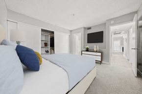 Las Vegas apartment for rent - a bedroom with a bed and a dresser with a television on the wall