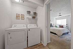 Lewisville apartment for rent - a washer and dryer in a bedroom with a bed