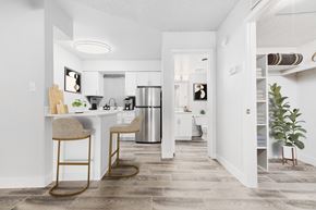 Tucson apartment for rent - an open kitchen and living room with a bar and stools