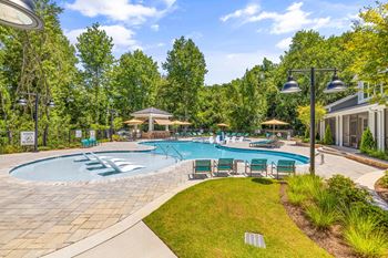 Resort-style pool with sunning deck and cabanas