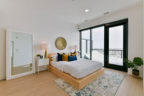 Winnipeg apartment for rent - a bedroom with a large bed and a large window