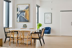 Winnipeg apartment for rent - a dining room with a table and chairs and a painting on the wall