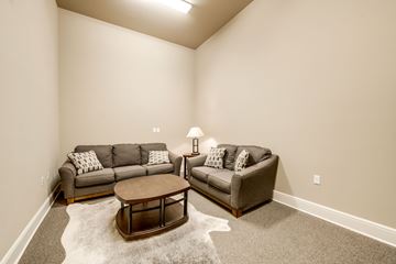 Greenville apartment for rent - A living room with a grey couch and a brown coffee table.