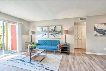 Texas City apartment for rent - A living room with a blue couch and a painting on the wall.