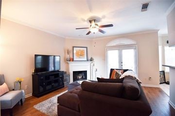 Houston apartment for rent - A living room with a brown couch and a fireplace.