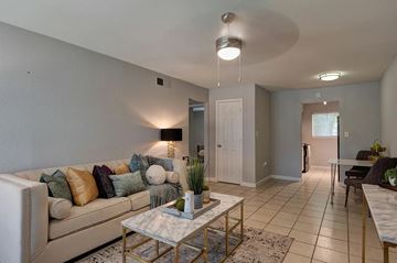 Houston apartment for rent - A living room with a white couch and a coffee table.